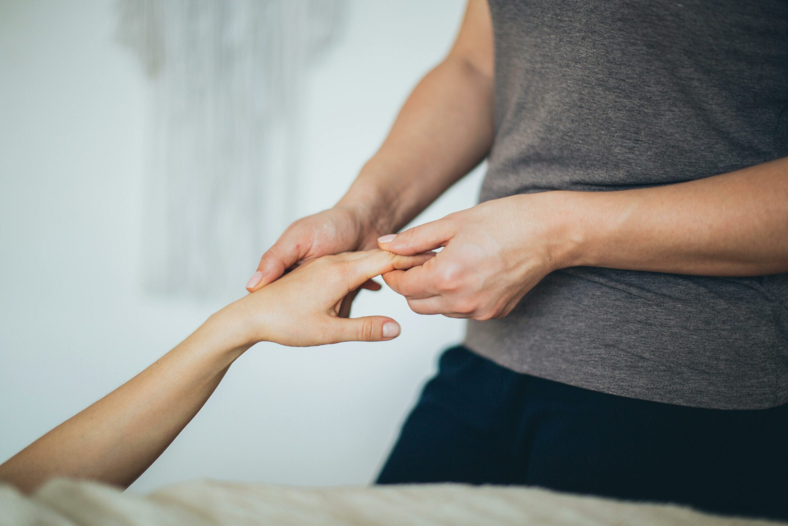 Close-up of a hand massage in a calming spa environment.